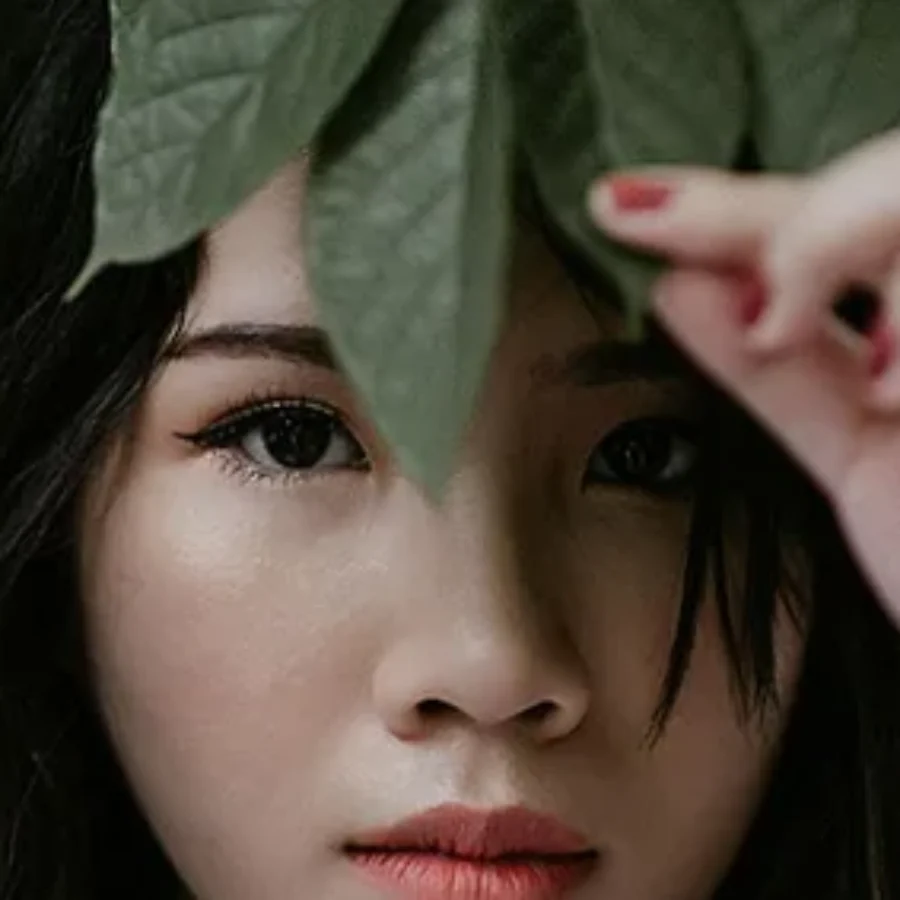 Open jar of white face cream with eucalyptus leaves on wood, top view For the page: Cosmetic 17. Use realistic, professional photography. Match the composition,
