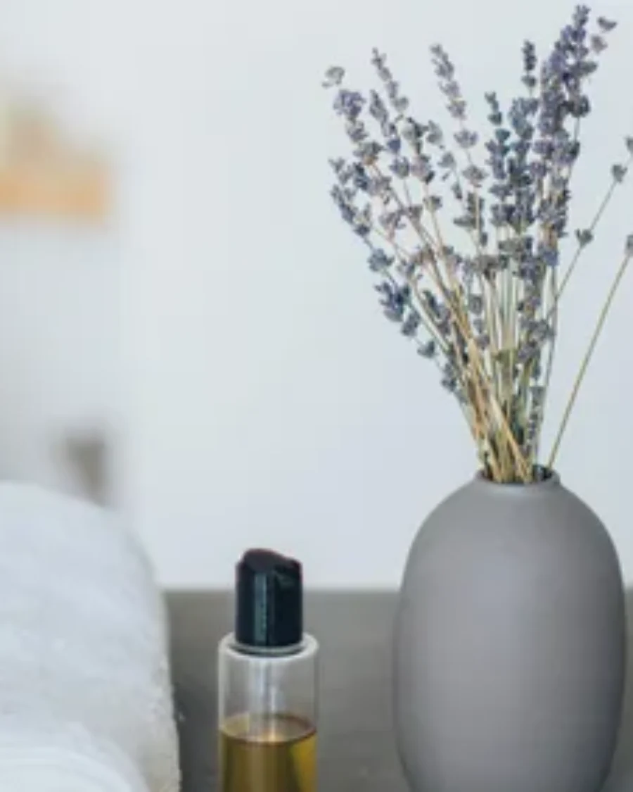 White dropper serum bottle on a textured stone podium, minimalist skincare product photo For the page: Cosmetic 17. Use realistic, professional photography. Mat