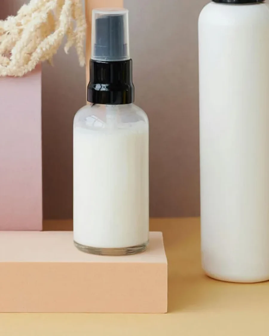 luxury cosmetic products including bottles and decorative elements on a light surface For the page: Cosmetic 15. Use realistic, professional photography. Match