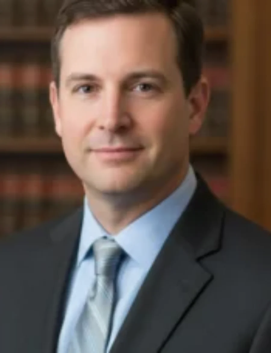 portrait of a male lawyer, Jess Kris For the page: Lawyer 1. Use realistic, professional photography. Match the composition, crop, and visual role of the mockup